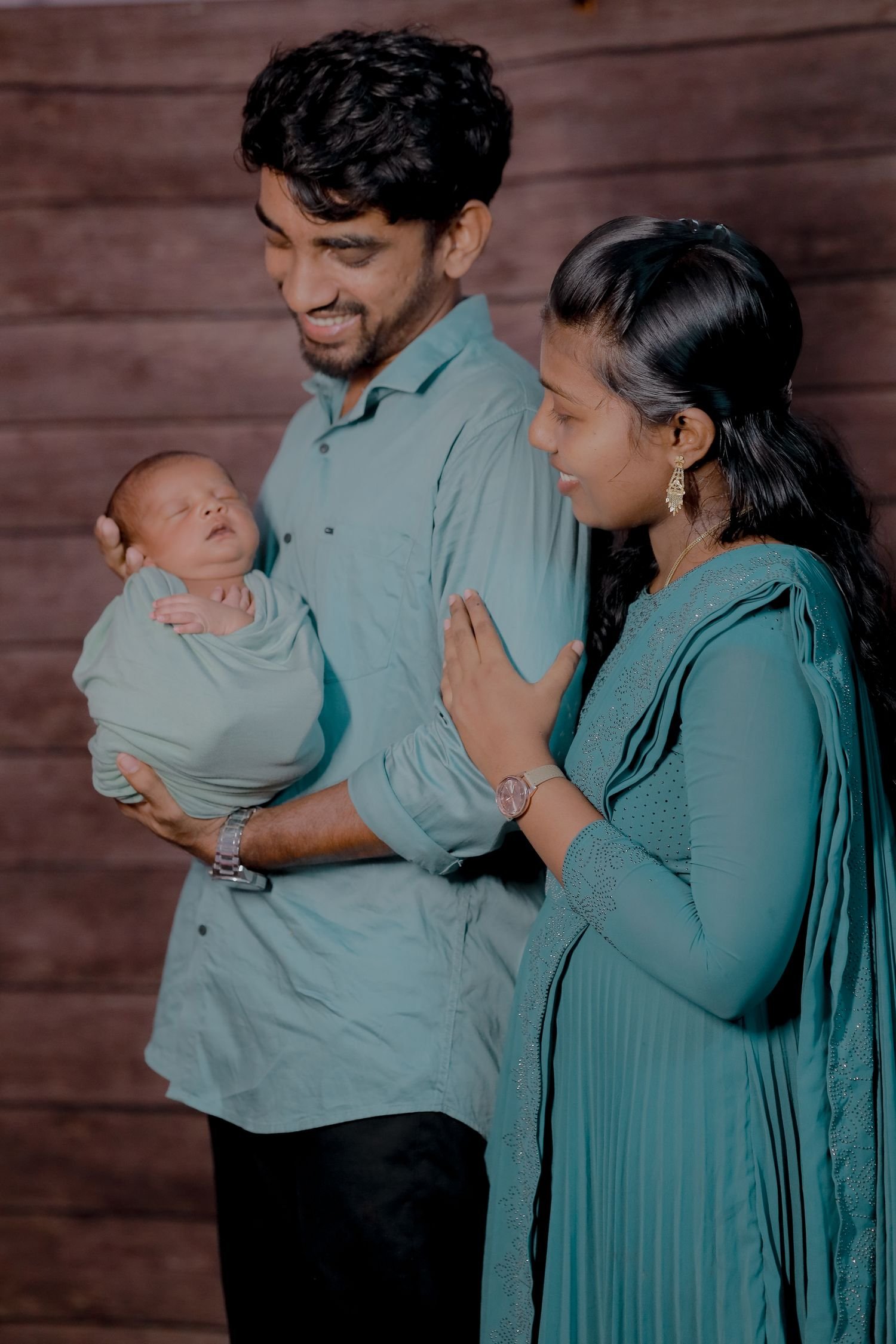 Family sharing a tender moment with a newborn baby